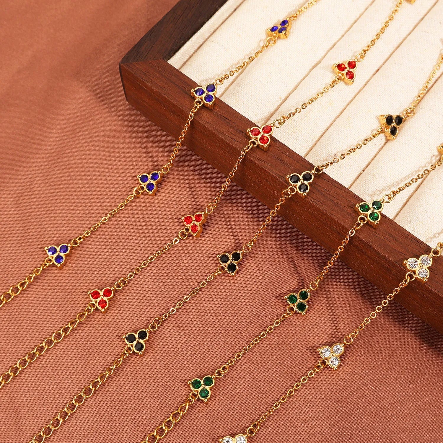 Geometric triangle women's bracelet in stainless steel with a choice of coloured centre stones on a gold or steel band.