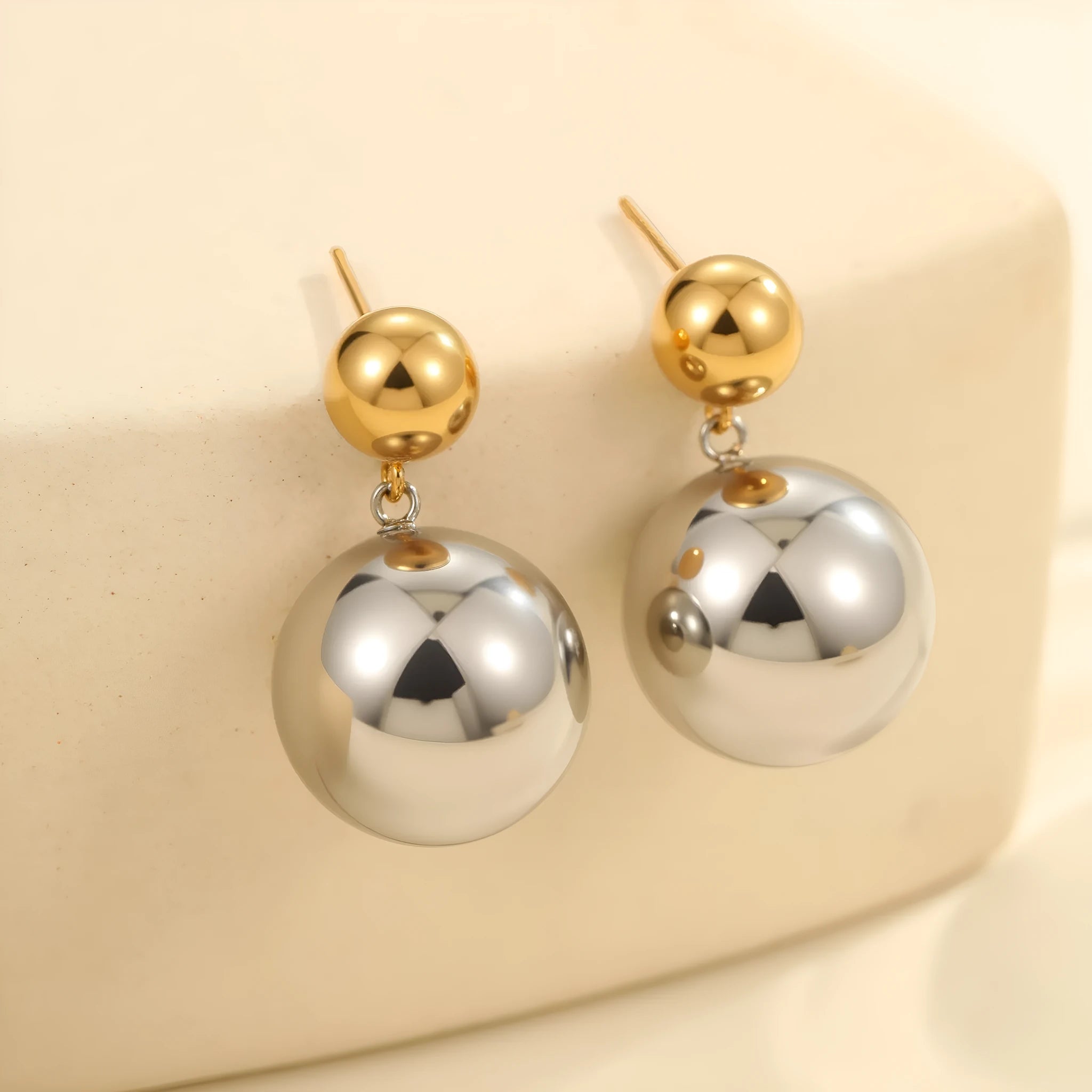 Women's geometric sphere ear studs with stainless steel construction and 18K gold electroplated colour-block finish