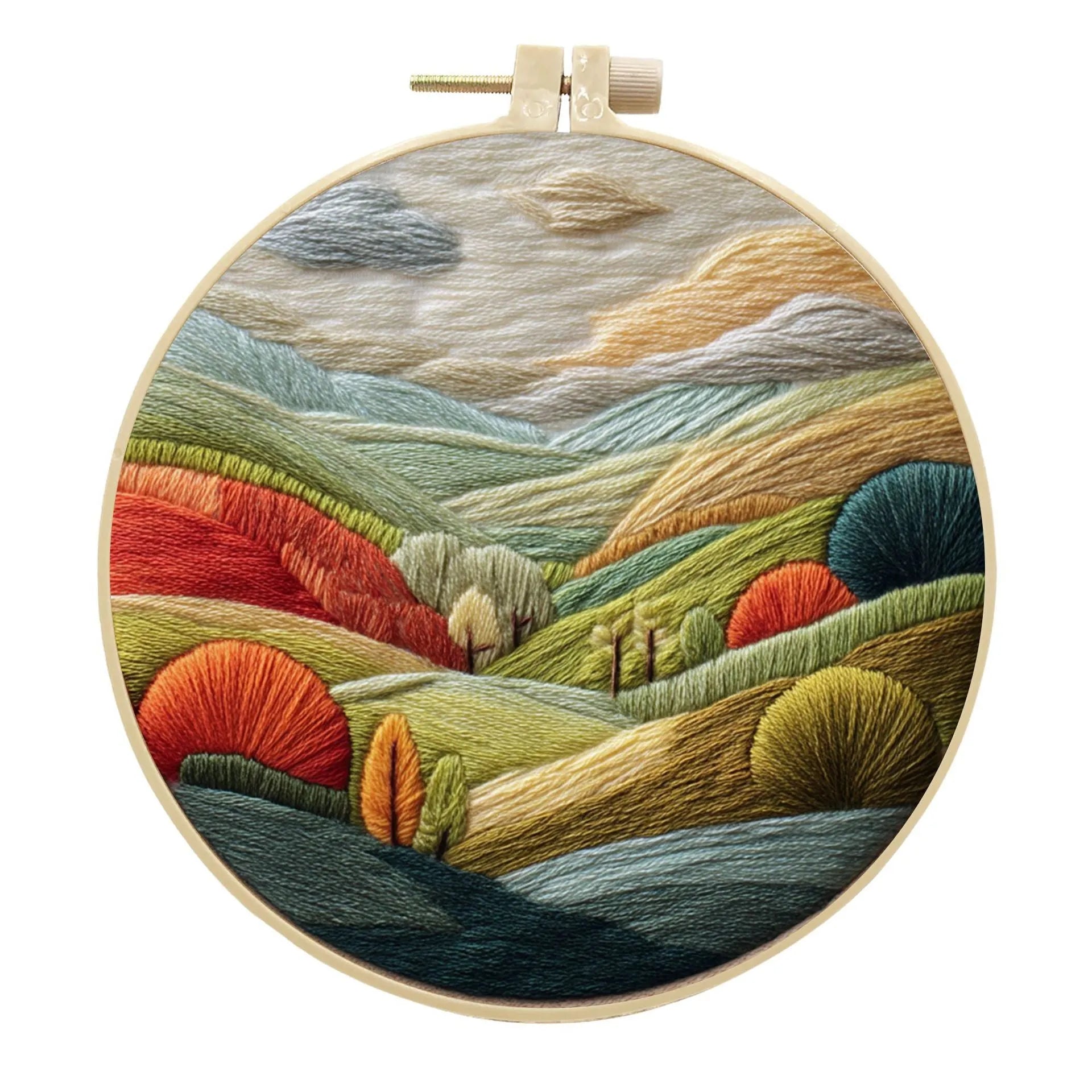 DIY embroidery kit with landscape-printed cotton fabric, embroidery hoop, needles, and coloured thread spools.