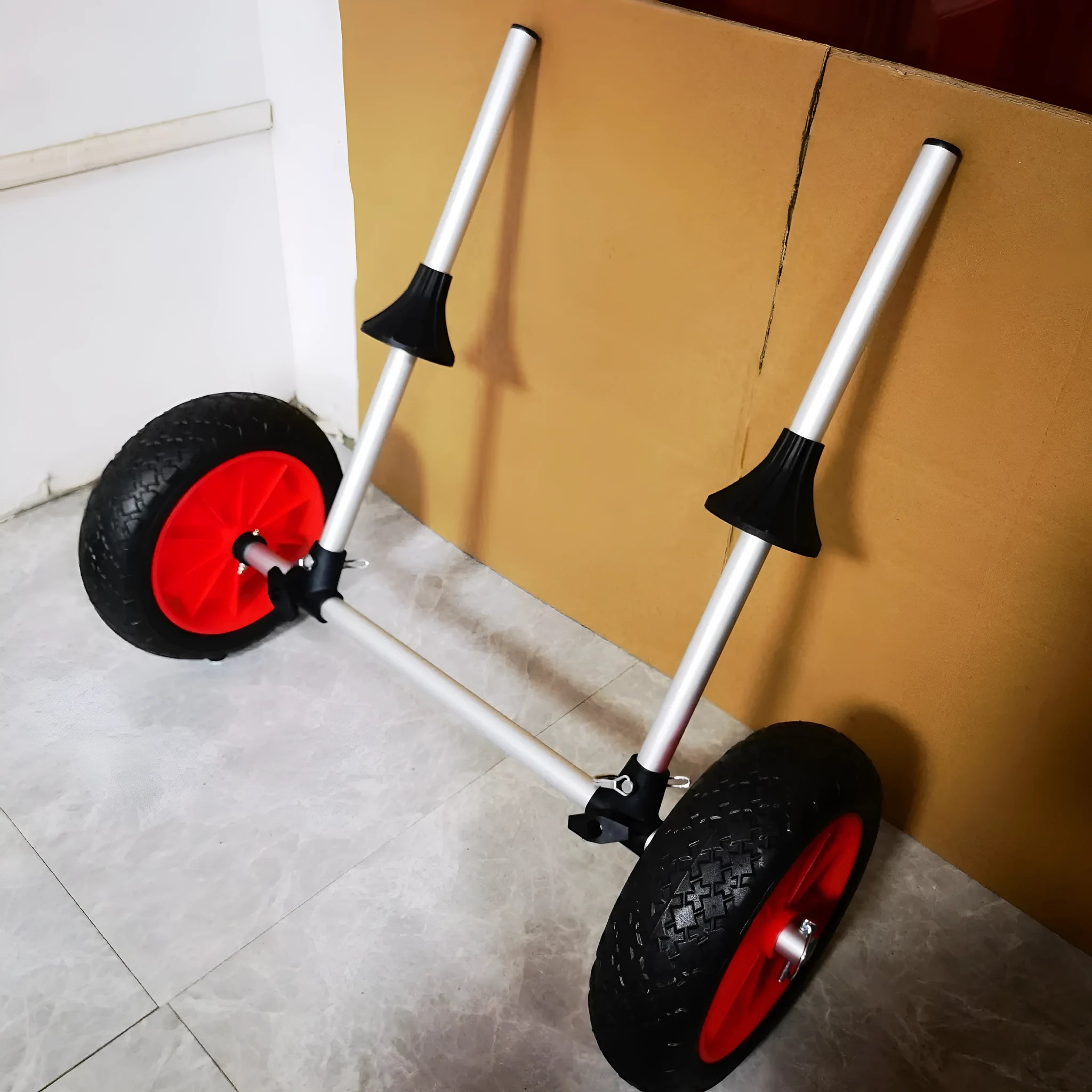 Foldable kayak beach trailer with aluminium frame and rubberised cradle for open kayak transport