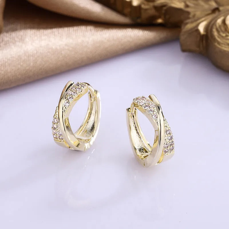 14K yellow geometric copper earrings with zircon accent on white background