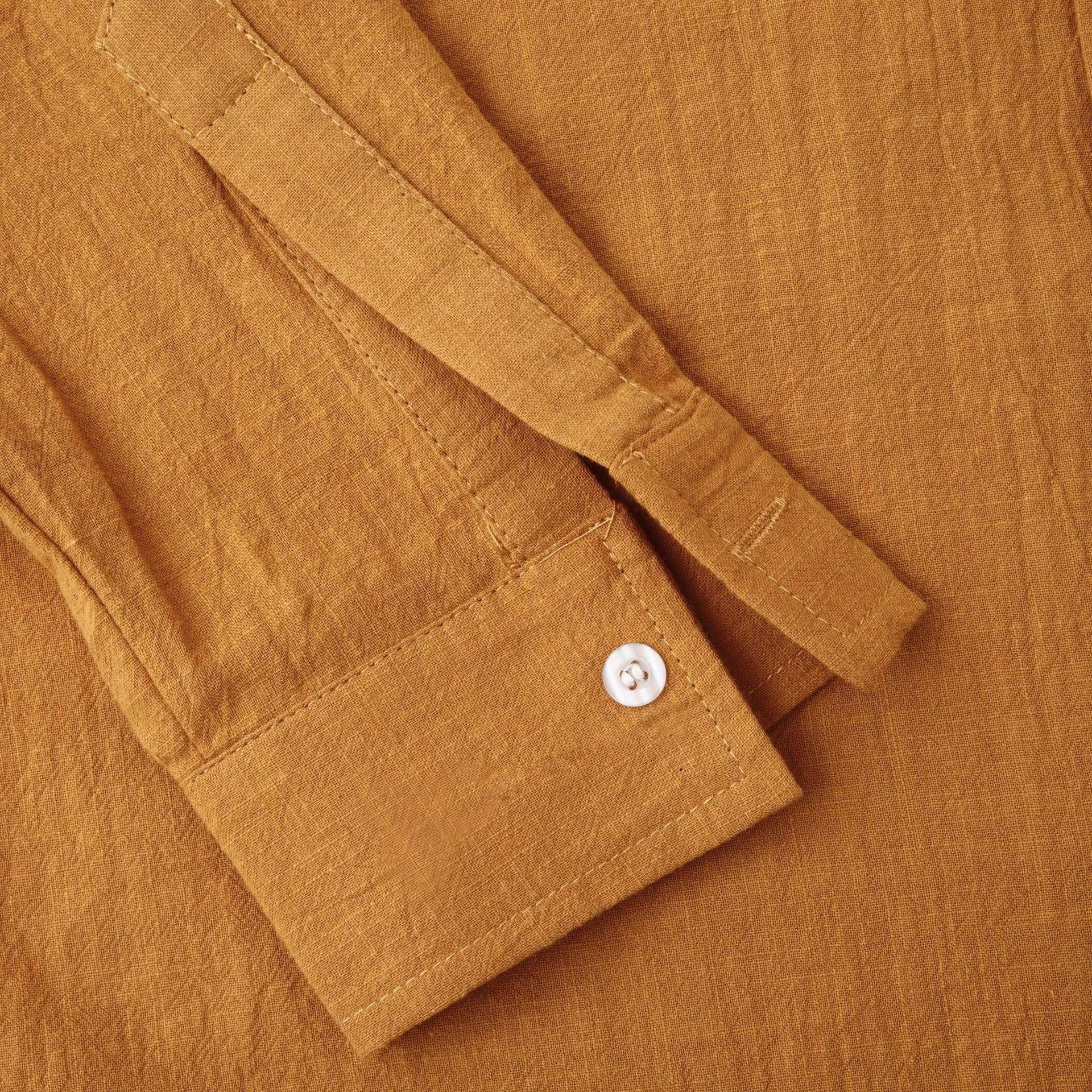 Brown men's slim fit long sleeve shirt and casual trousers set on a hanger.