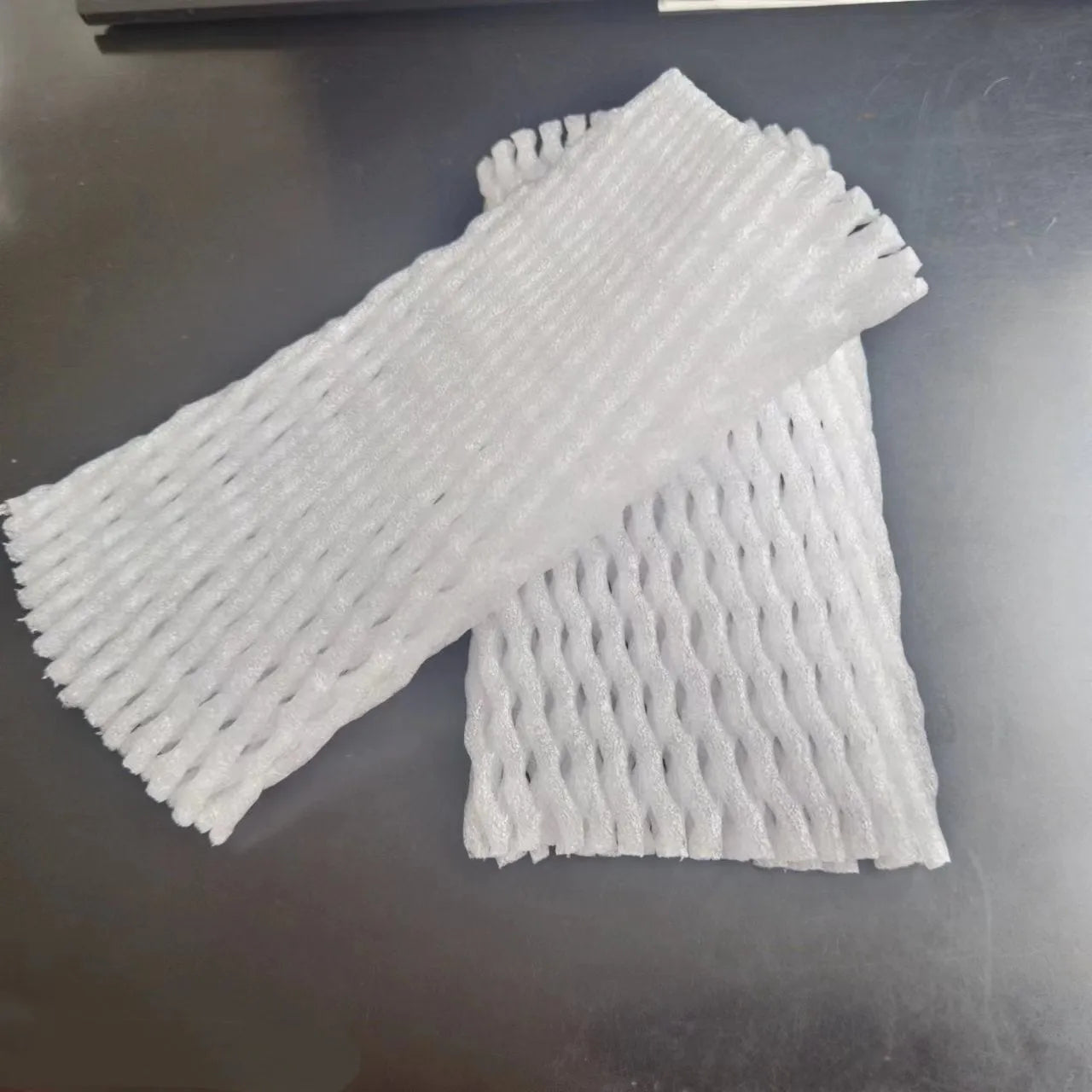 White foam shockproof protective net cover for fruit, shown in various sizes.