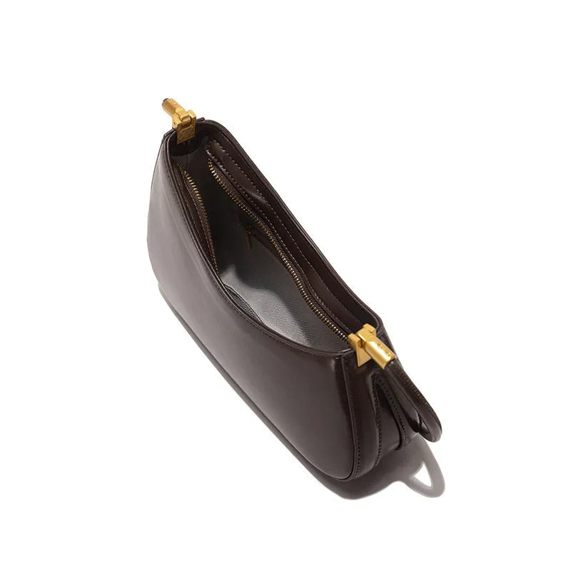 Women's oval shaped underarm bag in PU leather with single shoulder strap and internal zipper compartment