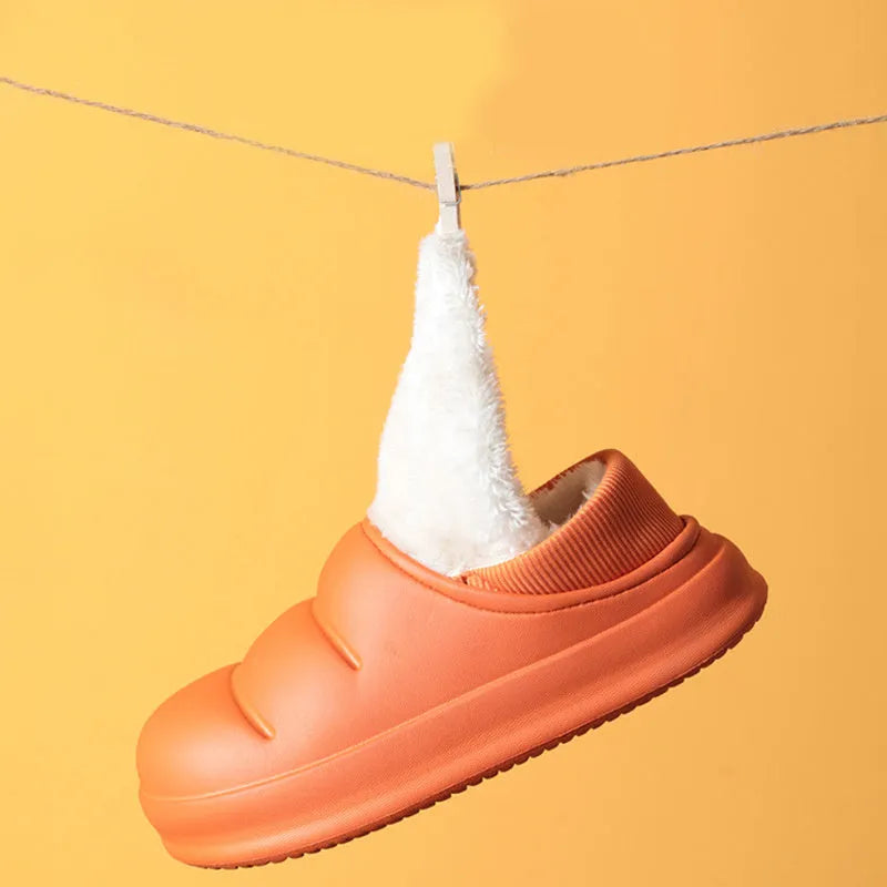 Women's green waterproof EVA winter slippers with plush lining and a non-slip sole.