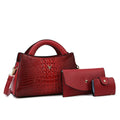 Women's black crocodile pattern PU leather crossbody handbag showing square shape and single shoulder strap.