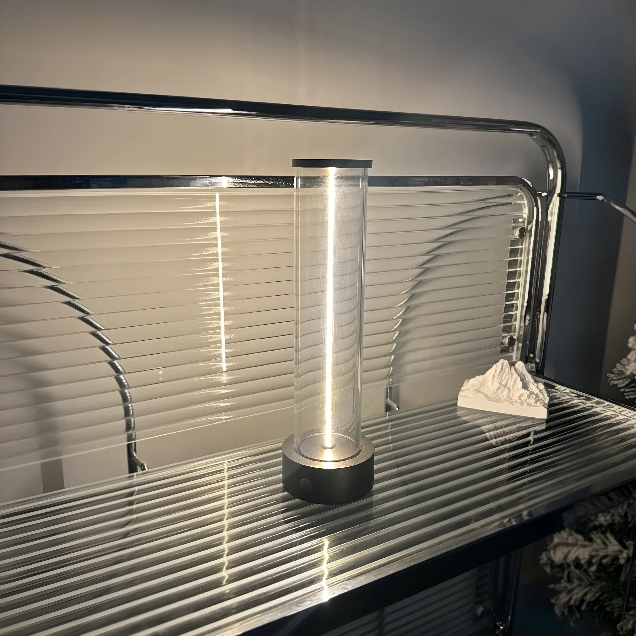 Grey modern LED line glass light strip with magnetic suction base for USB charging.