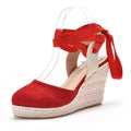 Women's red bohemian wedge sandals with buckle strap, tassel detail, and a fish mouth toe.