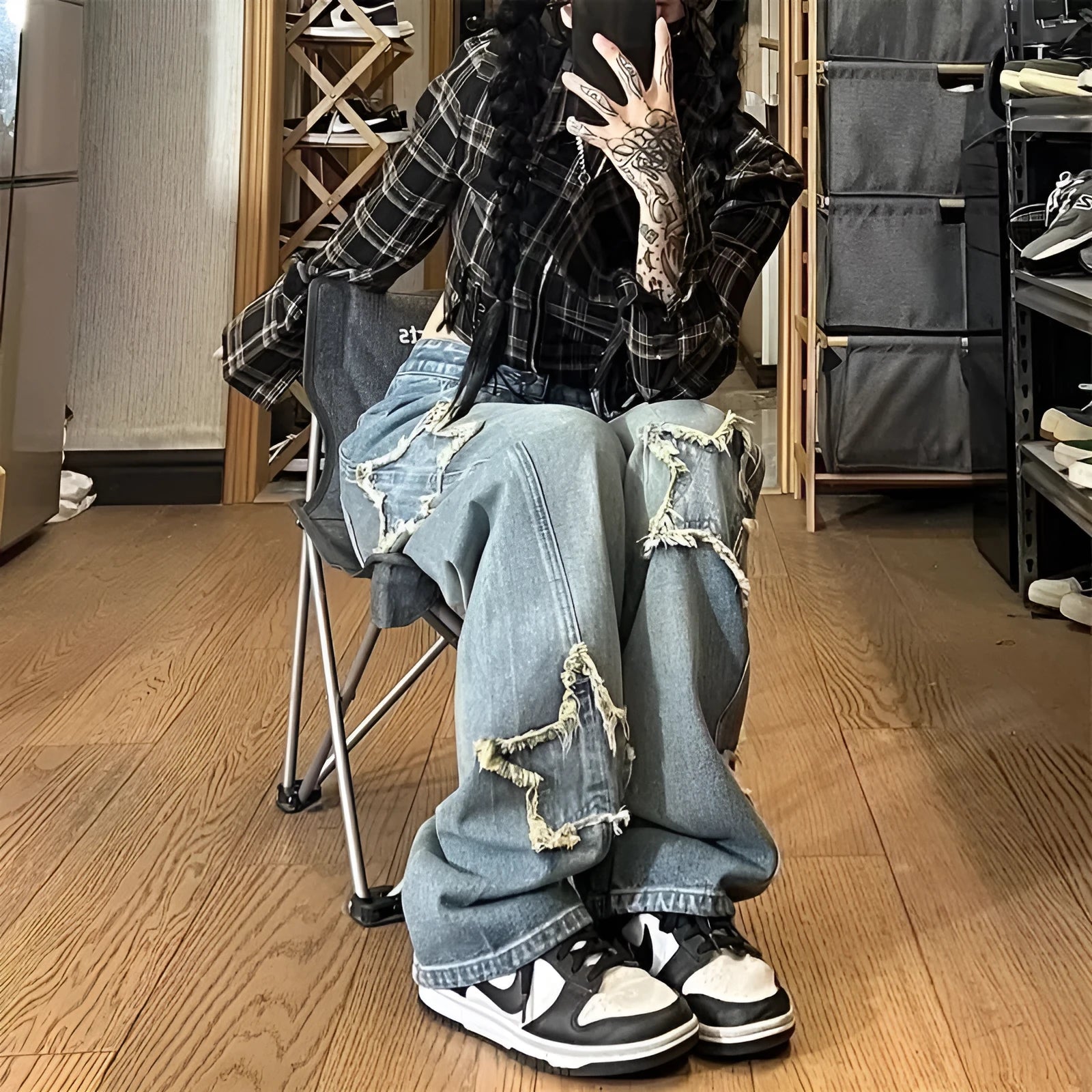 Blue high-waisted wide-leg denim trousers on a hanger, showing the straight-leg cut and front view.