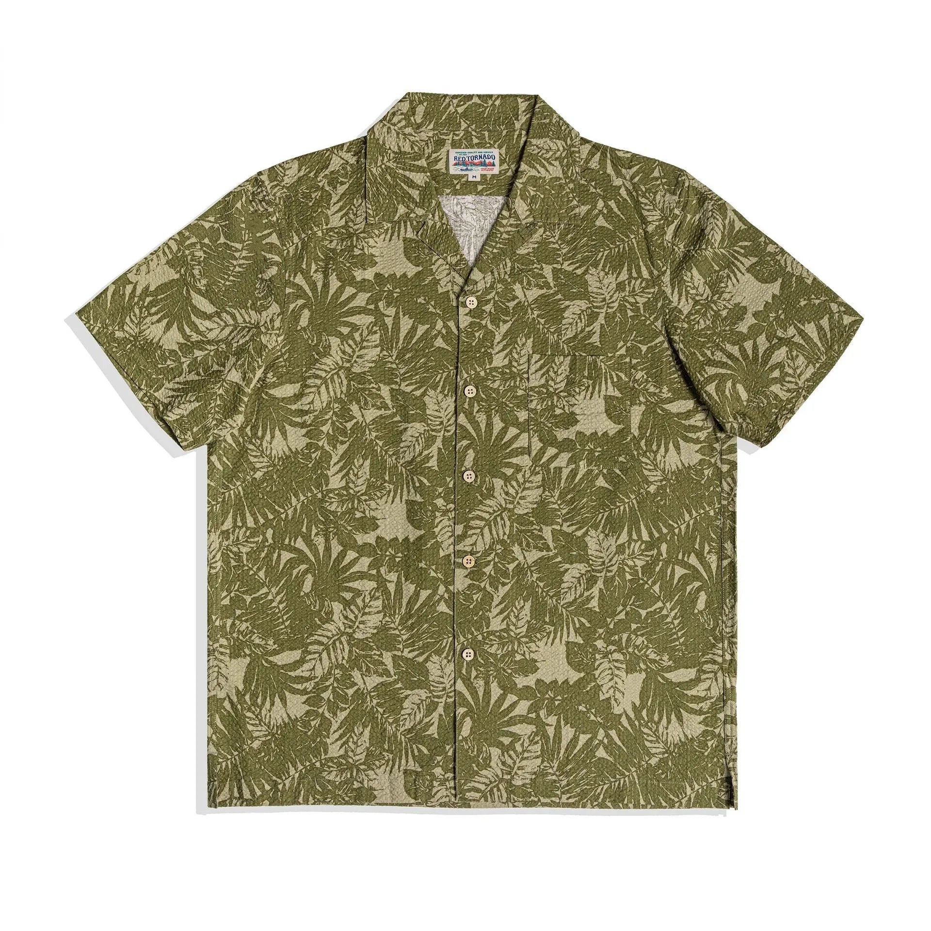 Man wearing a vintage floral print seersucker shirt with a Cuban collar in a green colour, showing loose fit.