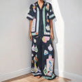 Black women's casual two-piece set with cartoon pattern cardigan and plain trousers