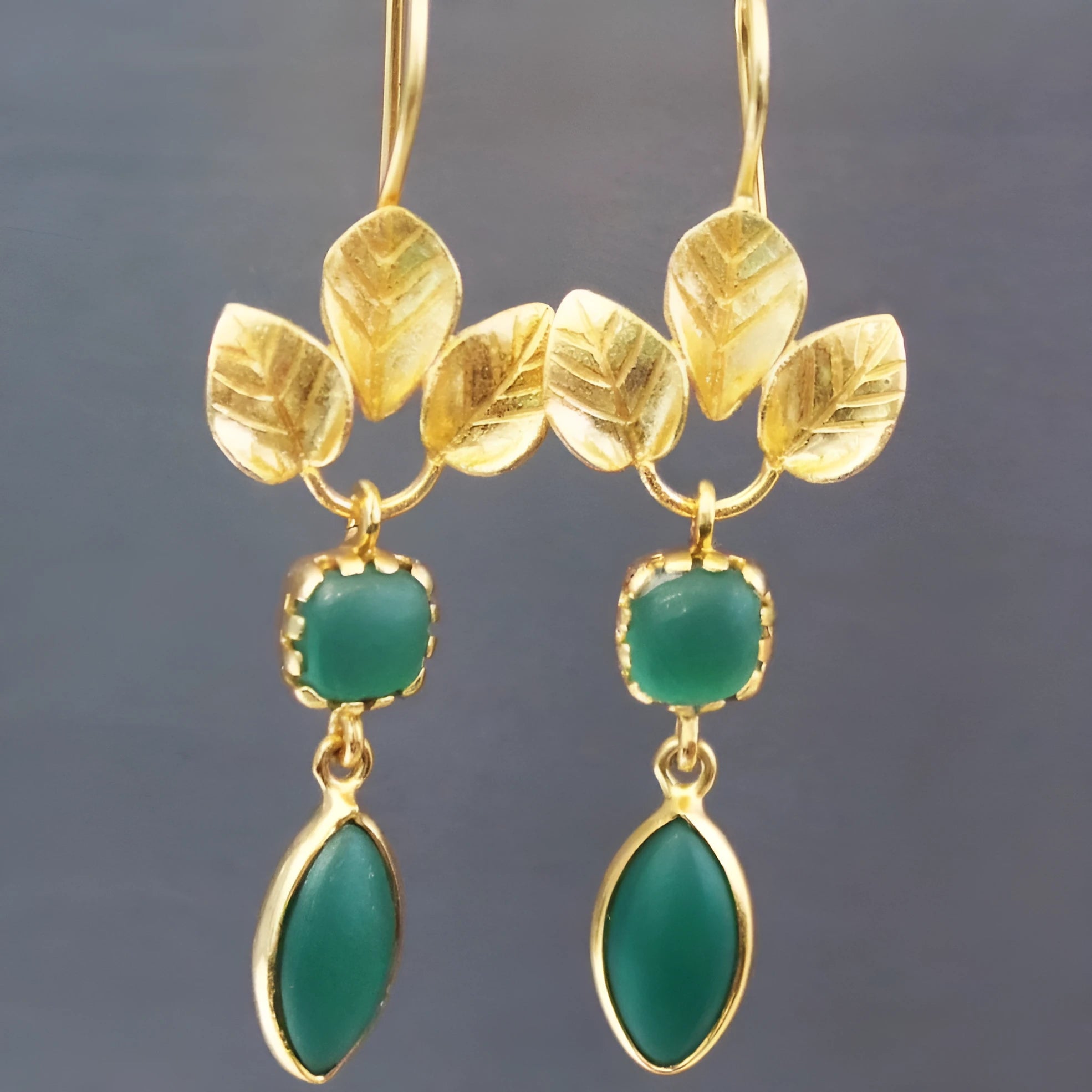 Gold drop-shaped earrings with tassel details and zircon accents on copper construction