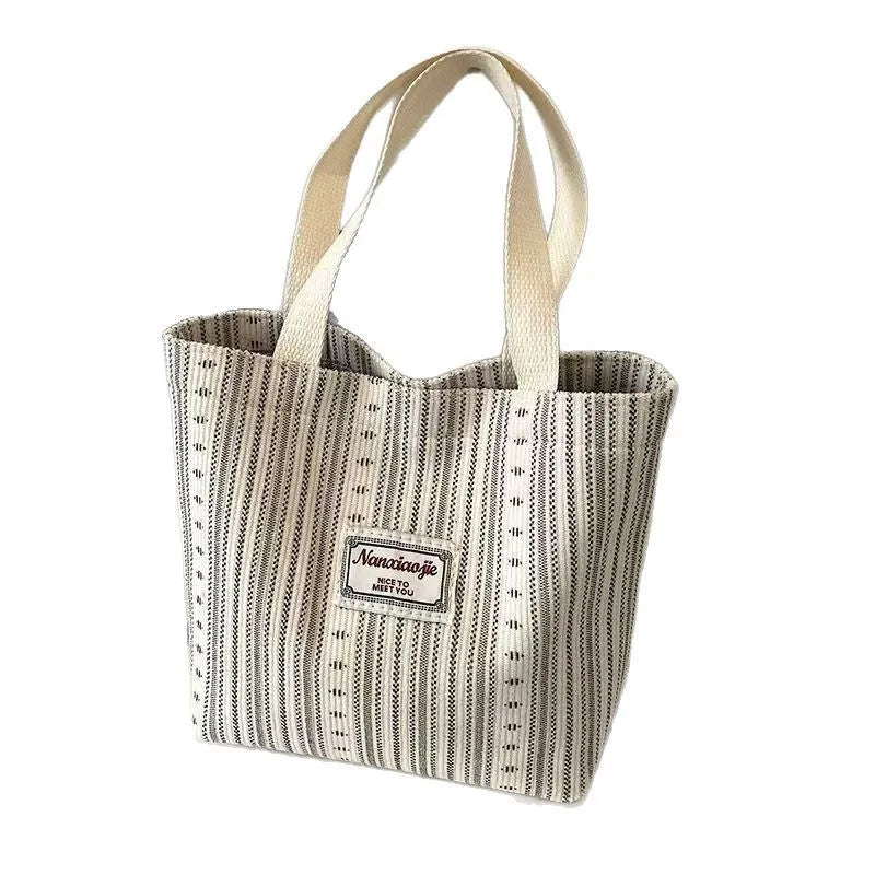 Japanese style corduroy handbag in dark brown showing textured fabric and minimalist design.
