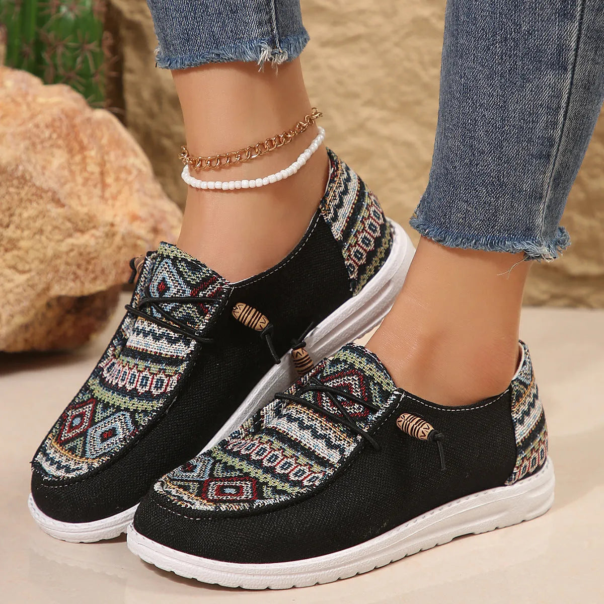 Women's low-top flat slip-on shoes in black with a round toe and rubber sole.