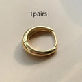 Women's minimalist copper water drop earrings in gold or silver, shown in large, medium, and small sizes.