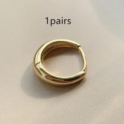 Women's minimalist copper water drop earrings in gold or silver, shown in large, medium, and small sizes.