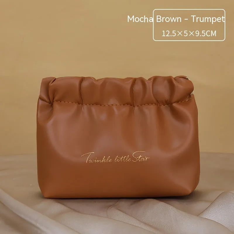 Leather travel toiletry bag in caramel mocha colour with large capacity and dry-wet separation compartments.