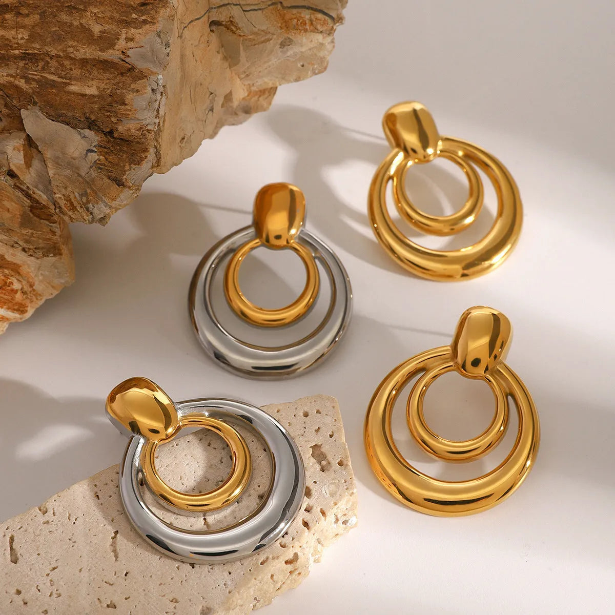 Gold geometric hollow stud earrings showing double layer round design with butterfly clutch backs