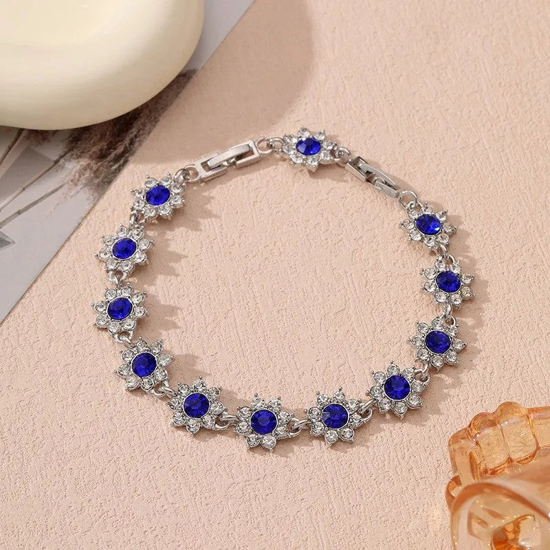Gold and silver electroplated flower bracelet with coloured gemstone accents on zinc alloy