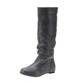 Women's flat slip-on long boots with round toe in black, shown on a foot.