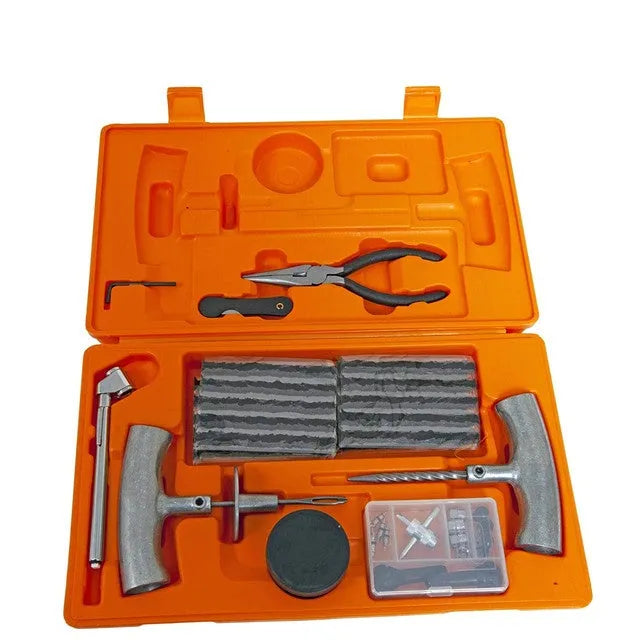 Open case showing emergency tyre repair tool set with reamer, insertion tool, pressure gauge, pliers, knife, and hex wrench.