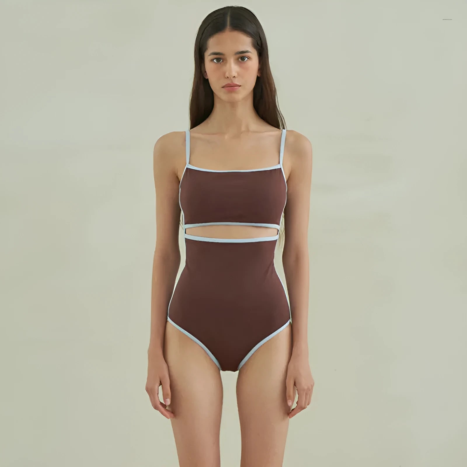 Brown triangle one-piece swimsuit for women on a hanger.