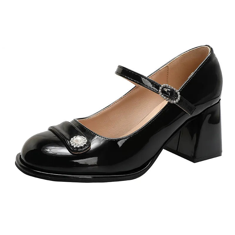 Women's black patent leather wide-fit chunky heel shoes with round toe and buckle fastening.