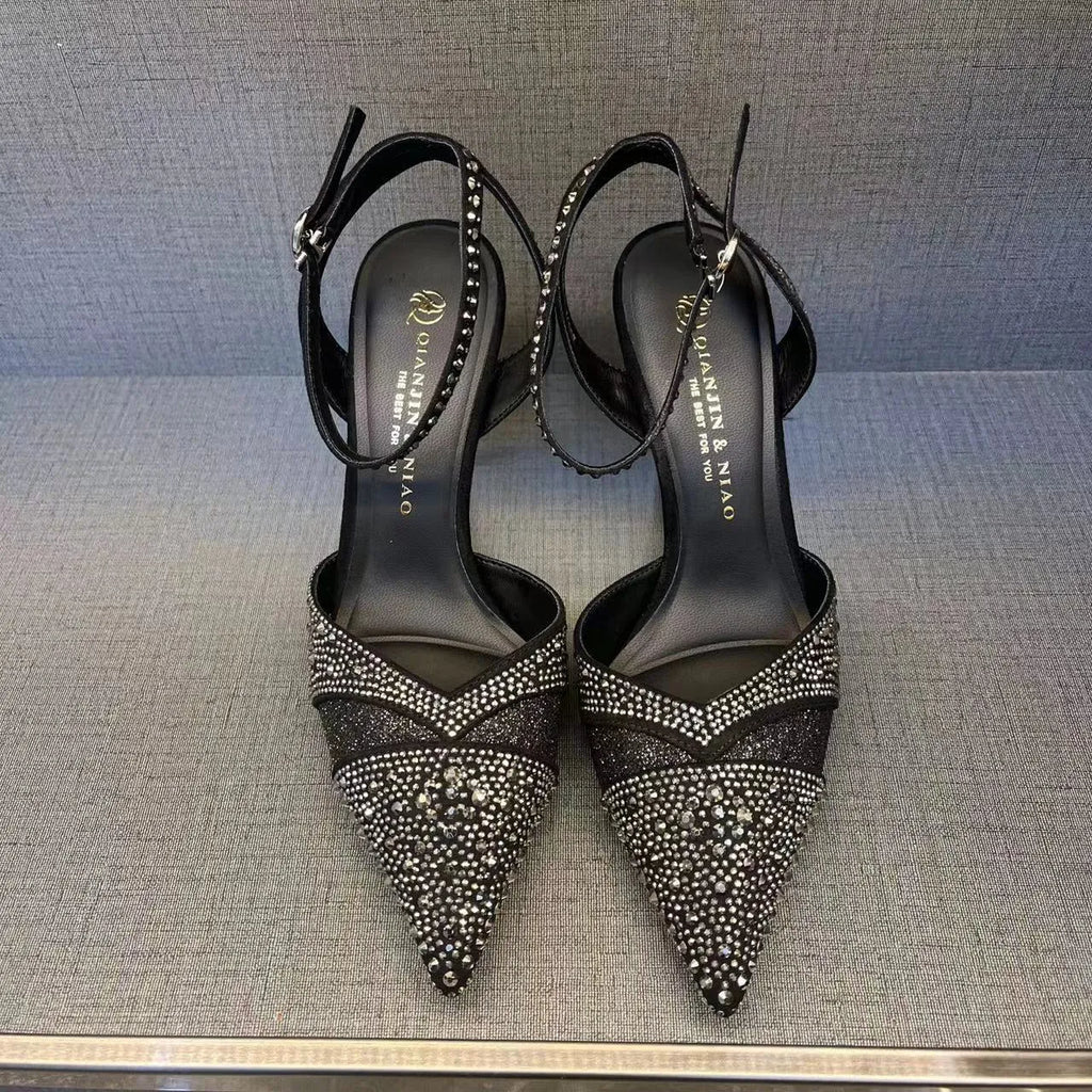 Women's black hollow high heels with red sole and pointed toe on a stiletto heel