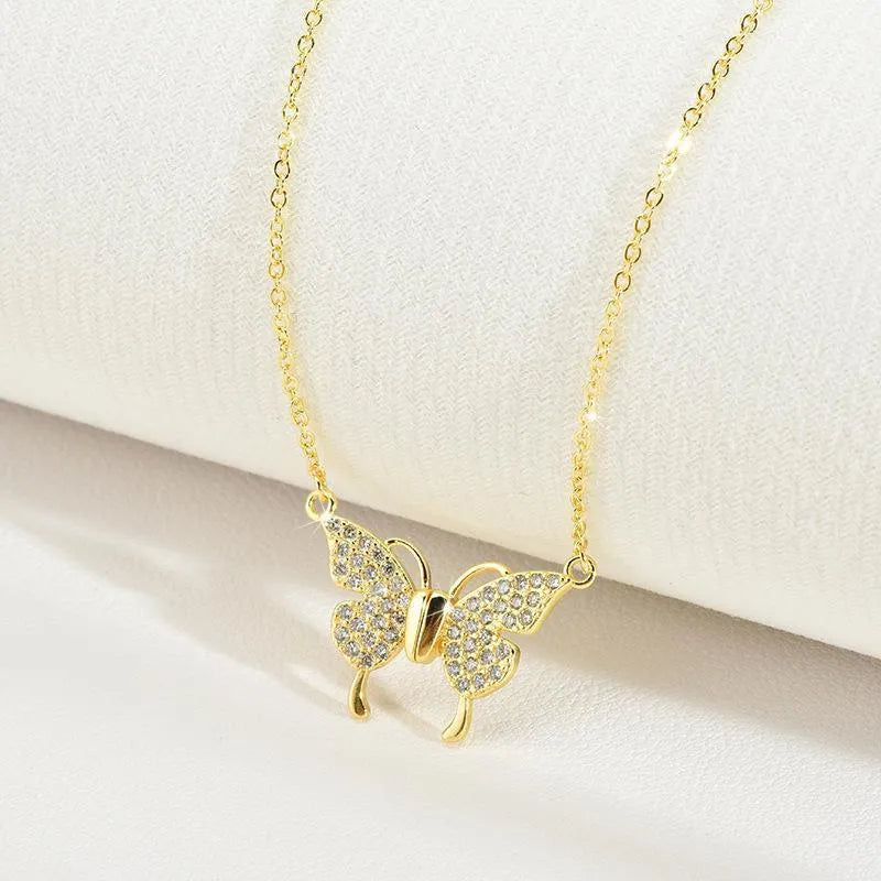 Gold clavicle chain necklace with magnetic butterfly charm and twisted chain design