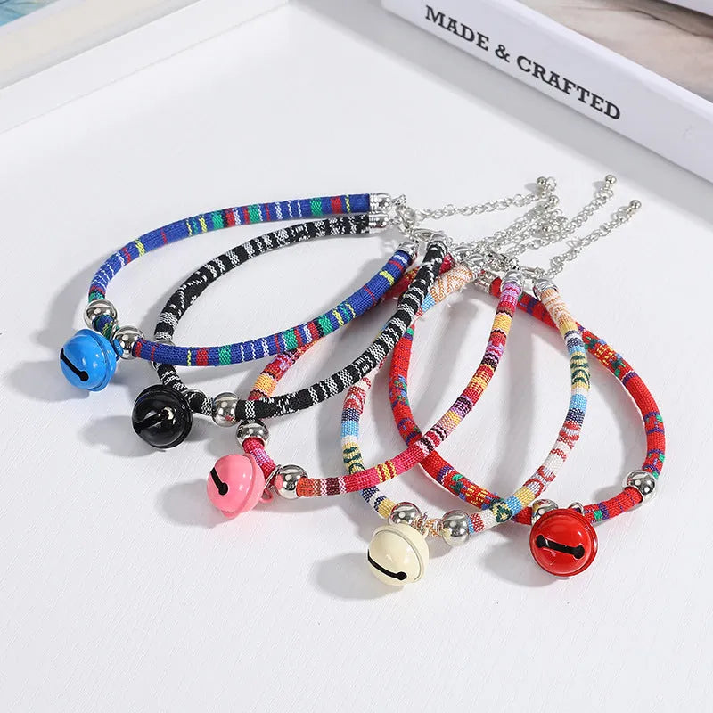 Ethnic patterned adjustable nylon pet collar with a metal buckle and bell in multiple colour options.