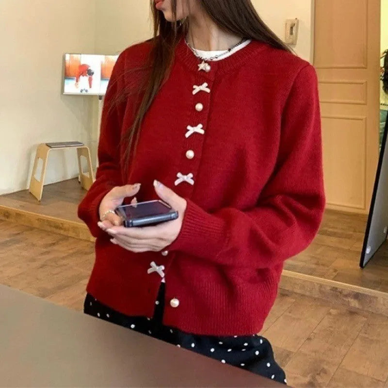Women's acrylic cashmere cardigan sweater with bow and pearl button detail in nine colour options