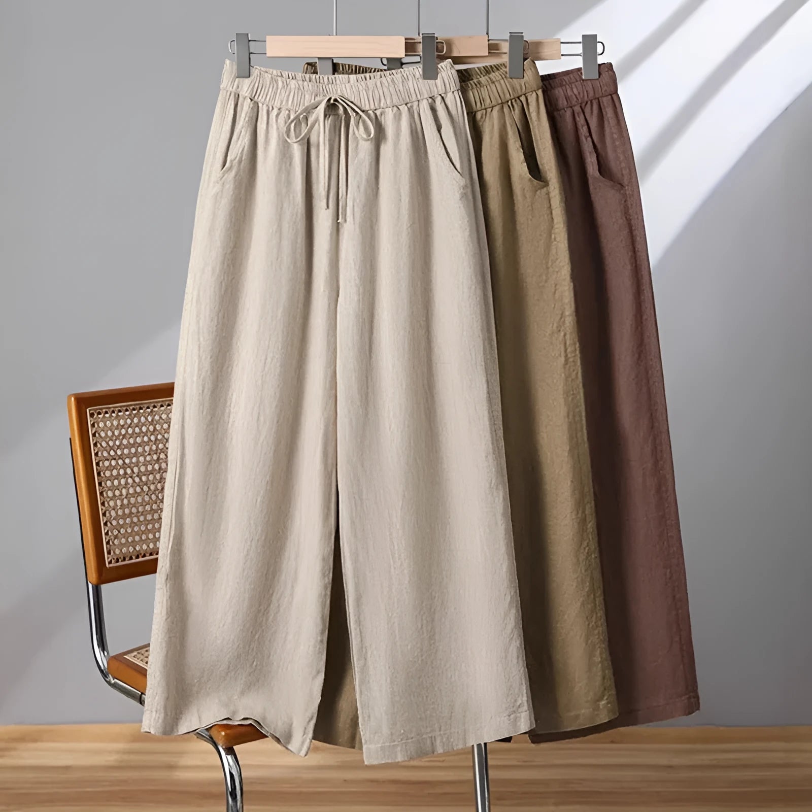 Women's apricot straight-leg casual trousers with elastic drawstring waist laid flat.
