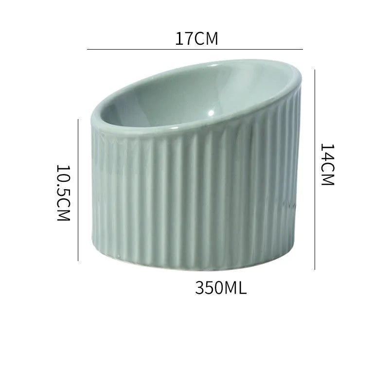A dark green round ceramic cat bowl elevated on a base, shown at an angle.