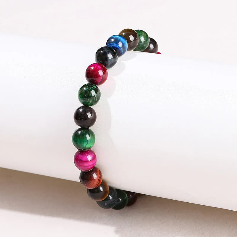 A colourful natural Tiger Eye beaded bracelet showing round beads on a string.