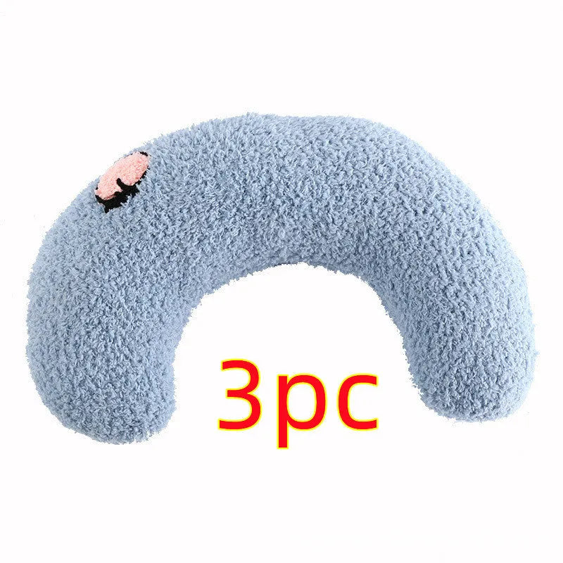 Small white U-shaped plush pet pillow for cats and small dogs on a neutral background.