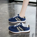 Light blue women's tennis shoes with cross shoulder straps and white rubber soles