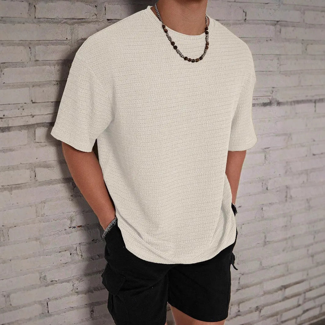 Men's loose fit light blue short sleeve round neck t-shirt on a hanger.