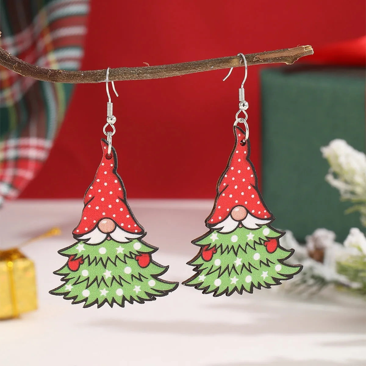 Wooden Christmas earrings with printed tree and snowman designs in geometric shapes