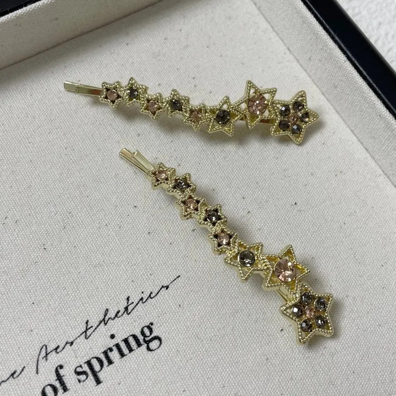 Gold Korean-style alloy hair barrettes with broken clip and star decoration.