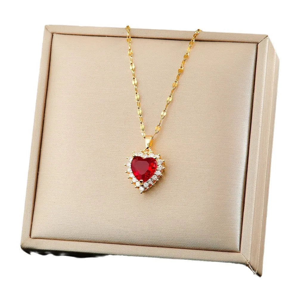 Gold-red titanium steel necklace and earrings set with heart-shaped flower pendant and gemstone detail.