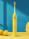 USB rechargeable electric toothbrush in yellow with small duck design and soft bristle head