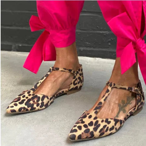 Women's leopard print pointed toe pumps with a low chunky heel and cross shoulder straps.