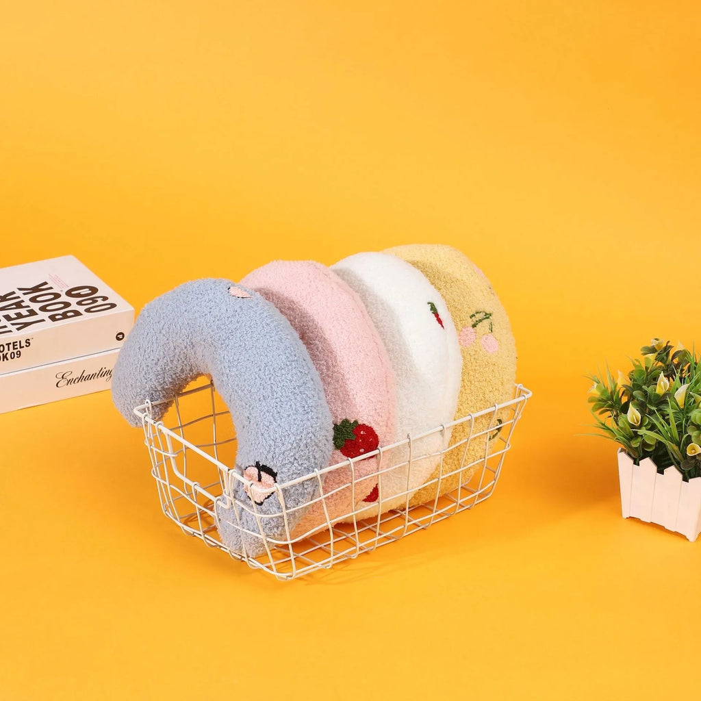 U-shaped half moon cloth pillow pet bed for cats in blue, pink, white, and yellow colours.
