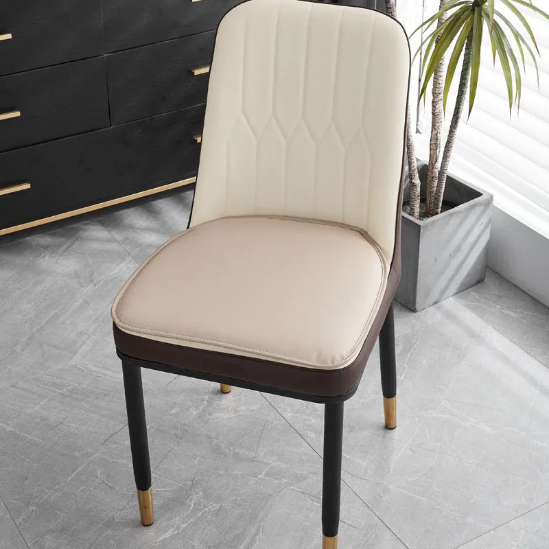 Leather horseshoe-shaped non-slip seat cushion in a solid colour on a chair.