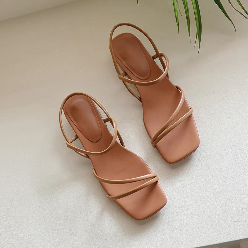 Women's flat green microfiber Roman sandals with square open toe on a white background.