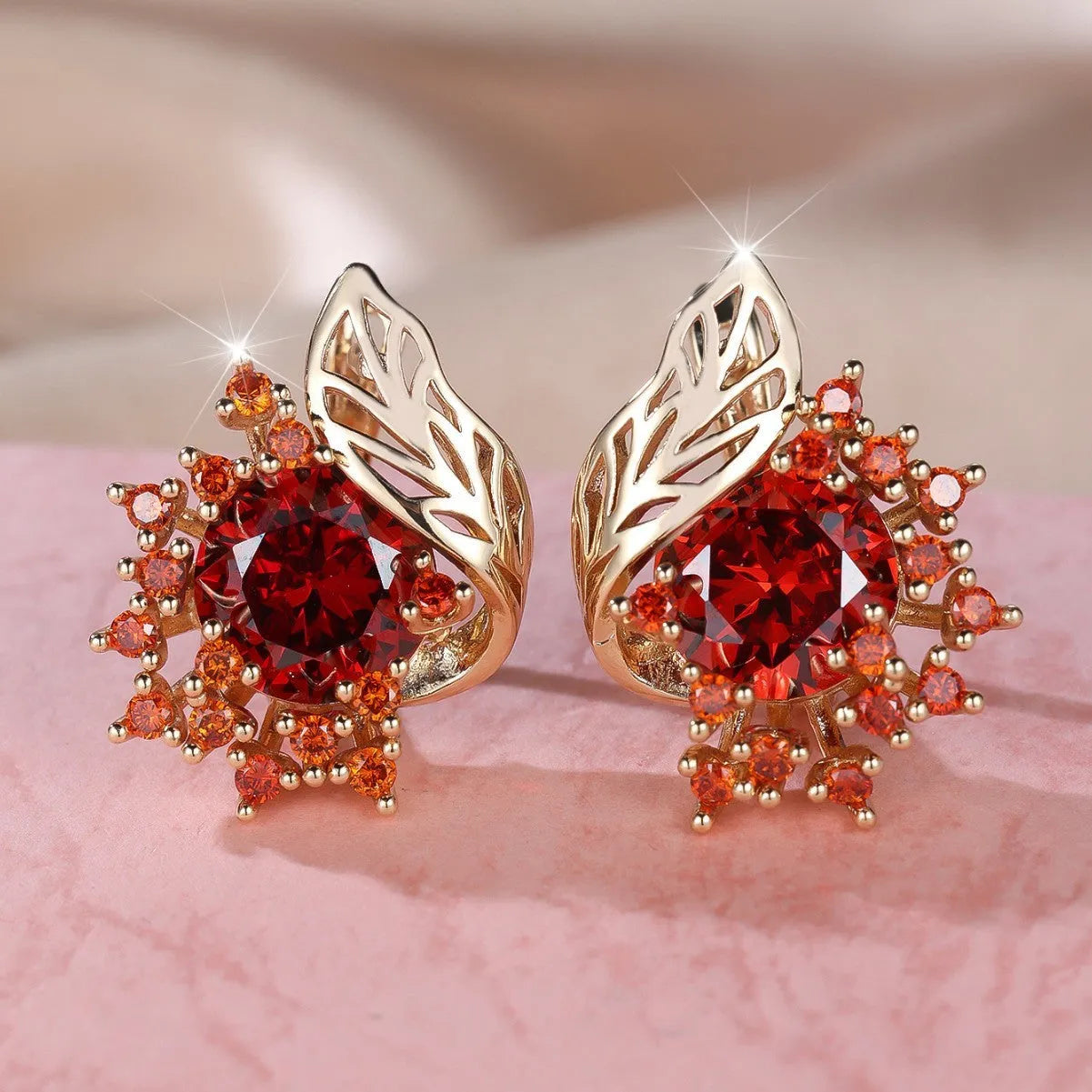 Round floral earrings with feather detailing and coloured zircon stones in champagne gold finish
