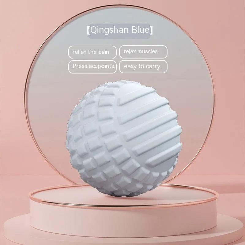 Blue peanut-shaped TPR foot massage ball on a wooden floor.