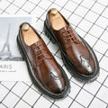 Men's black and brown brogue Oxford shoes with wingtip detailing and round toe