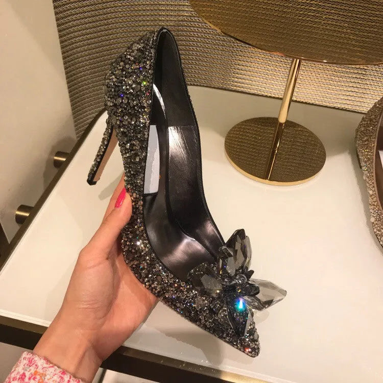 Gold women's pointed toe stiletto high heels with rhinestone and sequin decoration on a shallow-mouth, low-top upper.