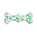 Green and white camouflage pattern natural rubber dog chew toy for large dogs on a wooden floor.